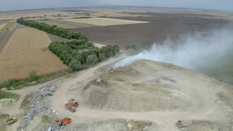 aerial view of a landfill with trucks and machinery