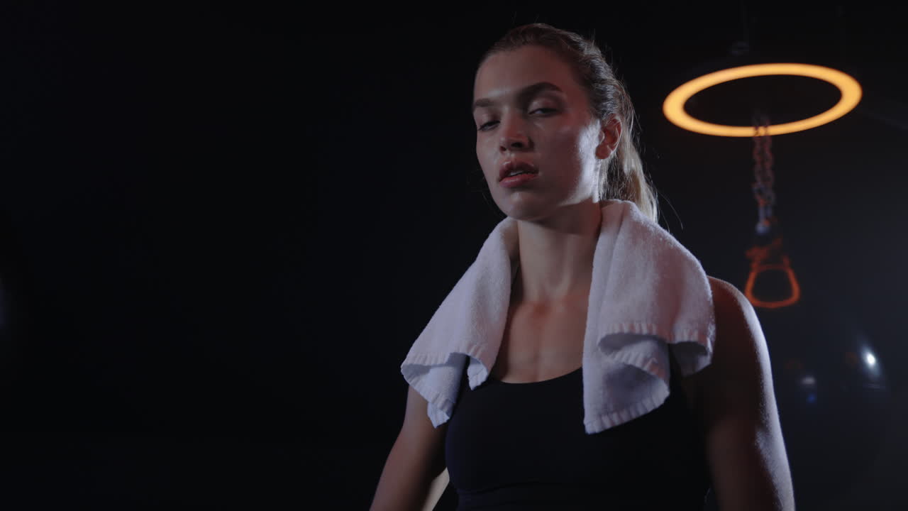 Woman Resting After a Workout in a Boxing Gym