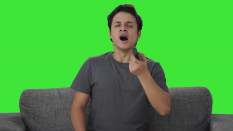 Tired-and-lazy-Indian-man-watching-TV-Green-screen