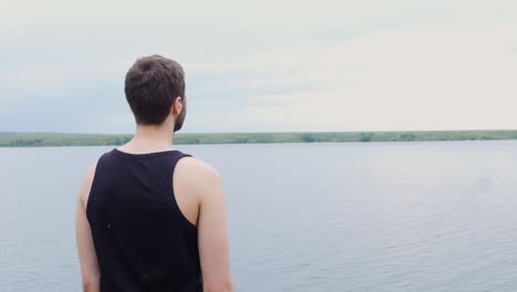 man contemplating by the lake