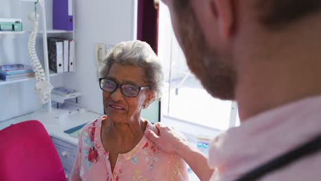 doctor examining a senior woman in a retirement home