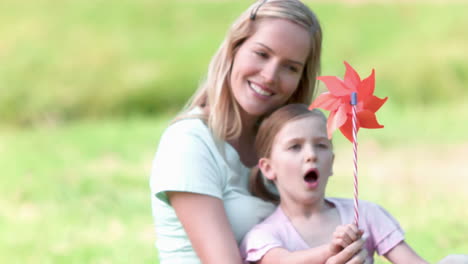 girl blowing in slow motion on a pinwheel