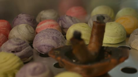 colorful chinese pastry smoke with aroma candle, close up