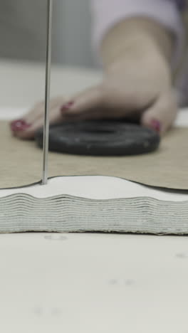 woman using tools for cutting fabric layers