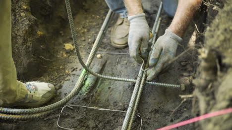 Construction-Worker-Using-Wire-Twister-on-Concrete-Rebar,-Close-Up