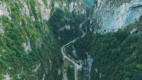 aerial view of a winding road through a canyon