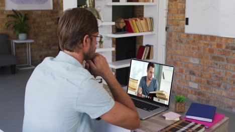 Caucasian-male-teacher-using-laptop-on-video-call-with-male-student