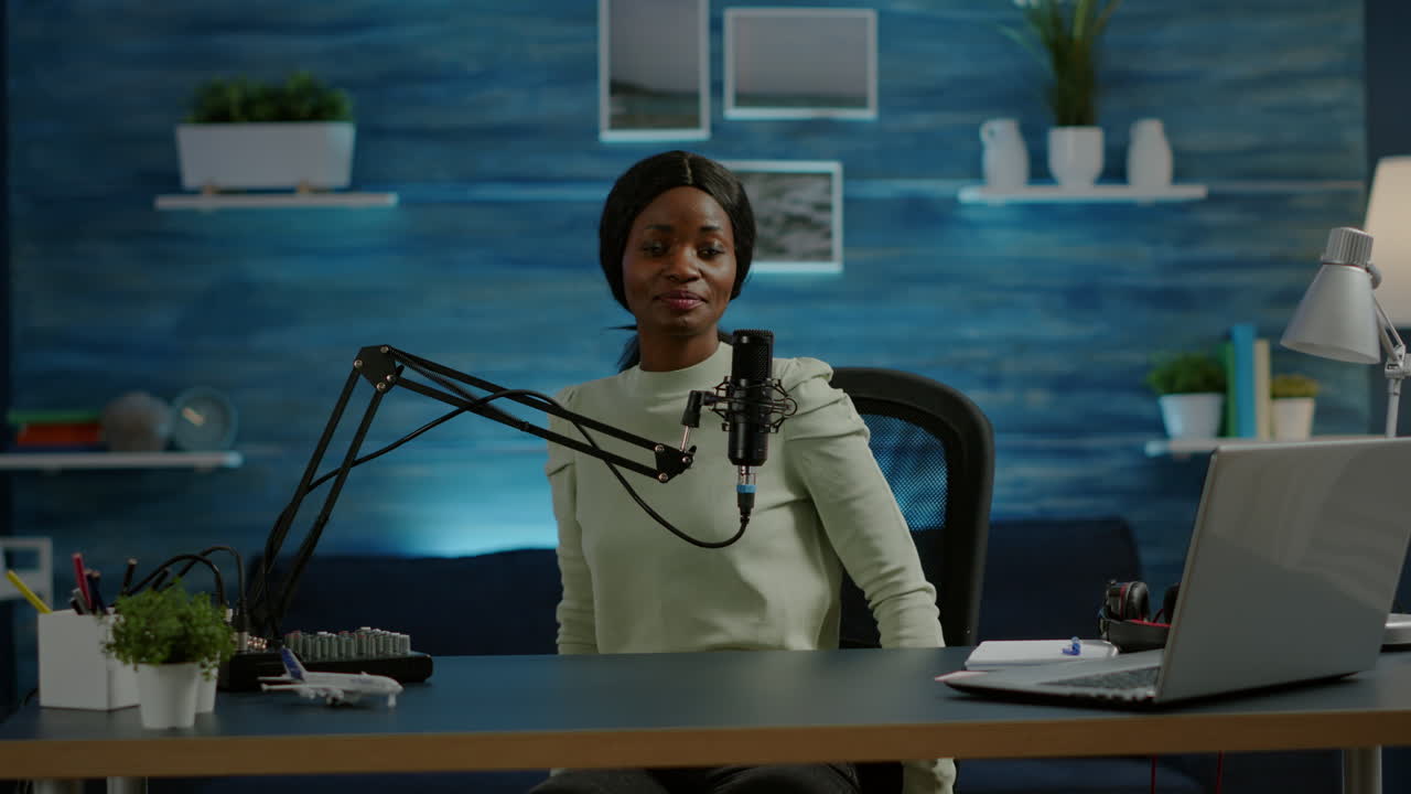 Portrait of african vlogger working in cozy studio