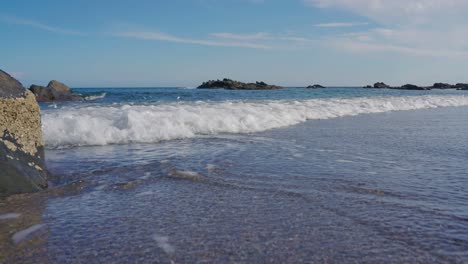 close up shot of ocean waves in slow motion at the beach