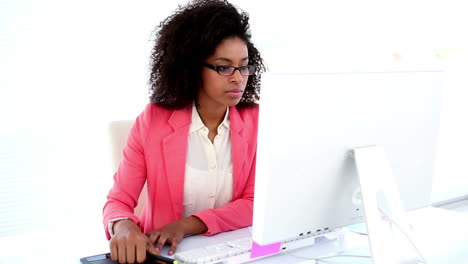 Pretty-designer-working-at-her-desk