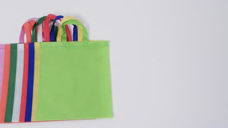 Video-of-multi-coloured-canvas-bags-with-copy-space-on-white-background