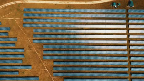solar panels photovoltaics in solar farm. aerial video footage, view of solar panels at a renewable energy energy of the future generation farm at sunset in lincolnshire, uk