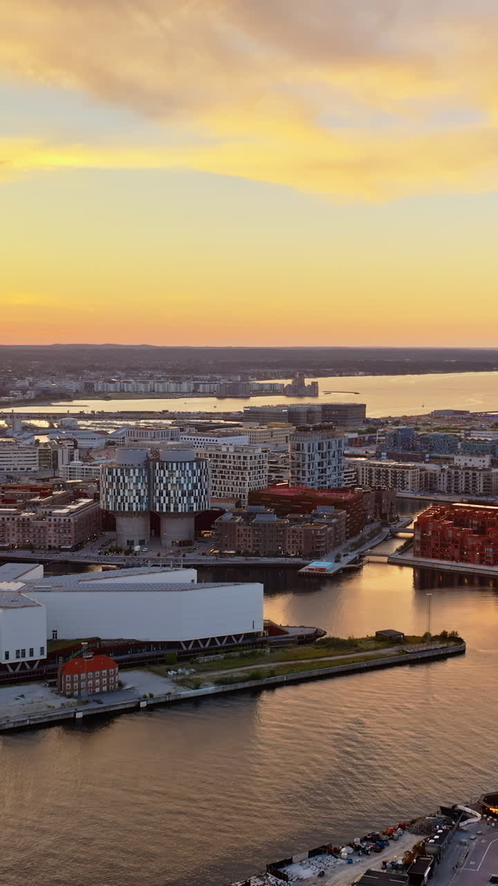 Aerial drone view of Nordhavn harbour area at the coast of the Oresund at sunset. Vertical