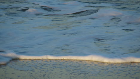 close up of the sea lapping onto the beach at caister on sea