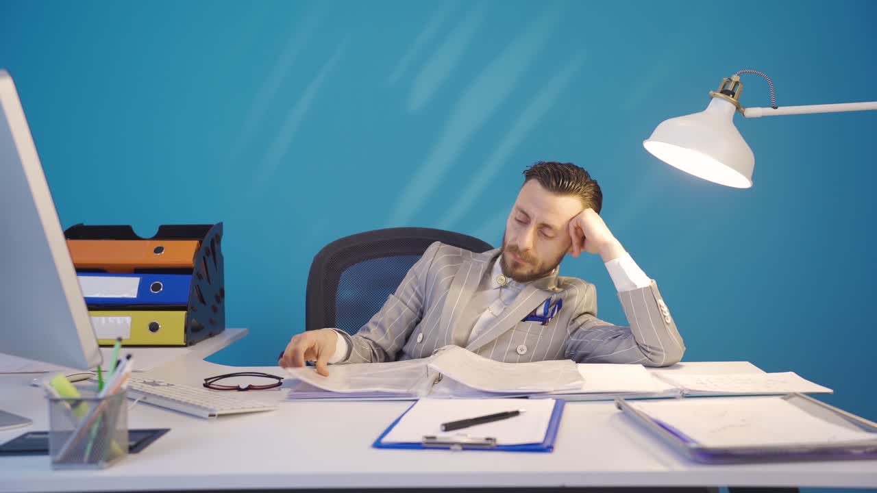The bored businessman does not want to work and is overwhelmed.