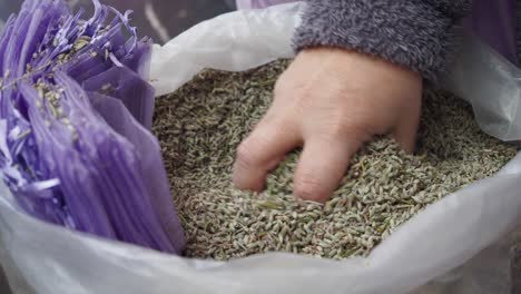 woman selling dried lavender at a market