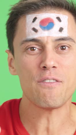 close up of a man supporting south korean team