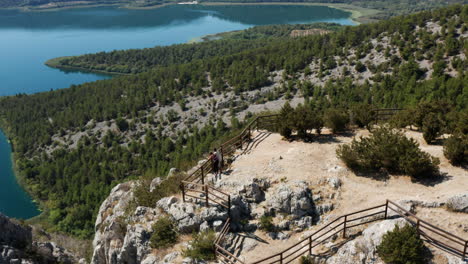 tourists enjoying amazing scenery at the viewpoint in krka national park, croatia - aerial drone shot