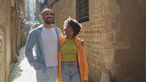 couple walking and embracing on a city street