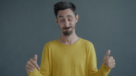 man in a yellow shirt pointing