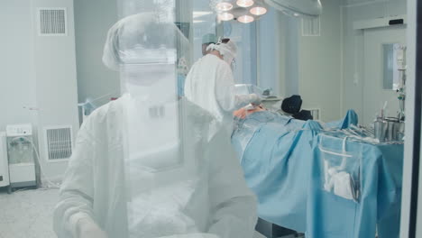 surgical nurse sets up instruments for bypass surgery. worker arranges workplace ready for surgeon to perform coronary artery bypass surgery