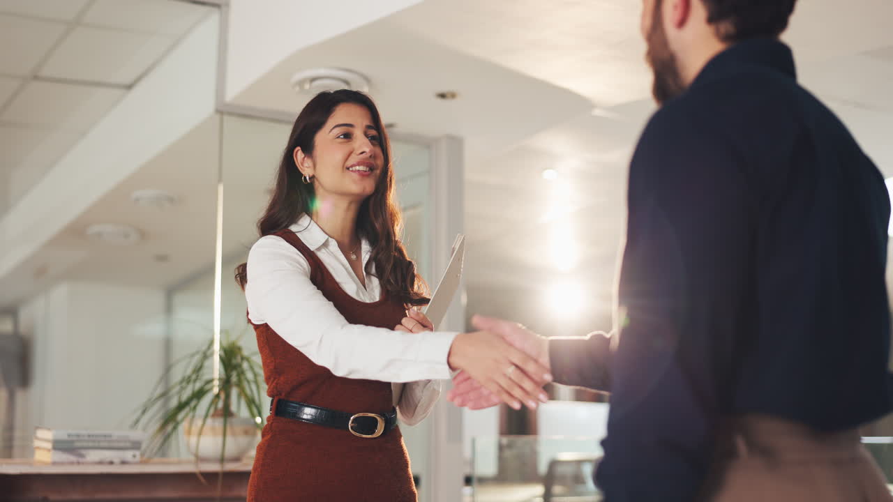 Business professionals shaking hands in an office setting