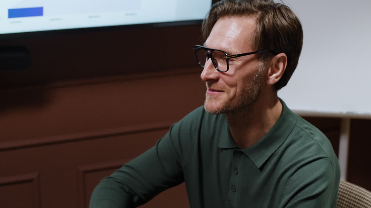 Professional man in glasses participating in a meeting or presentation