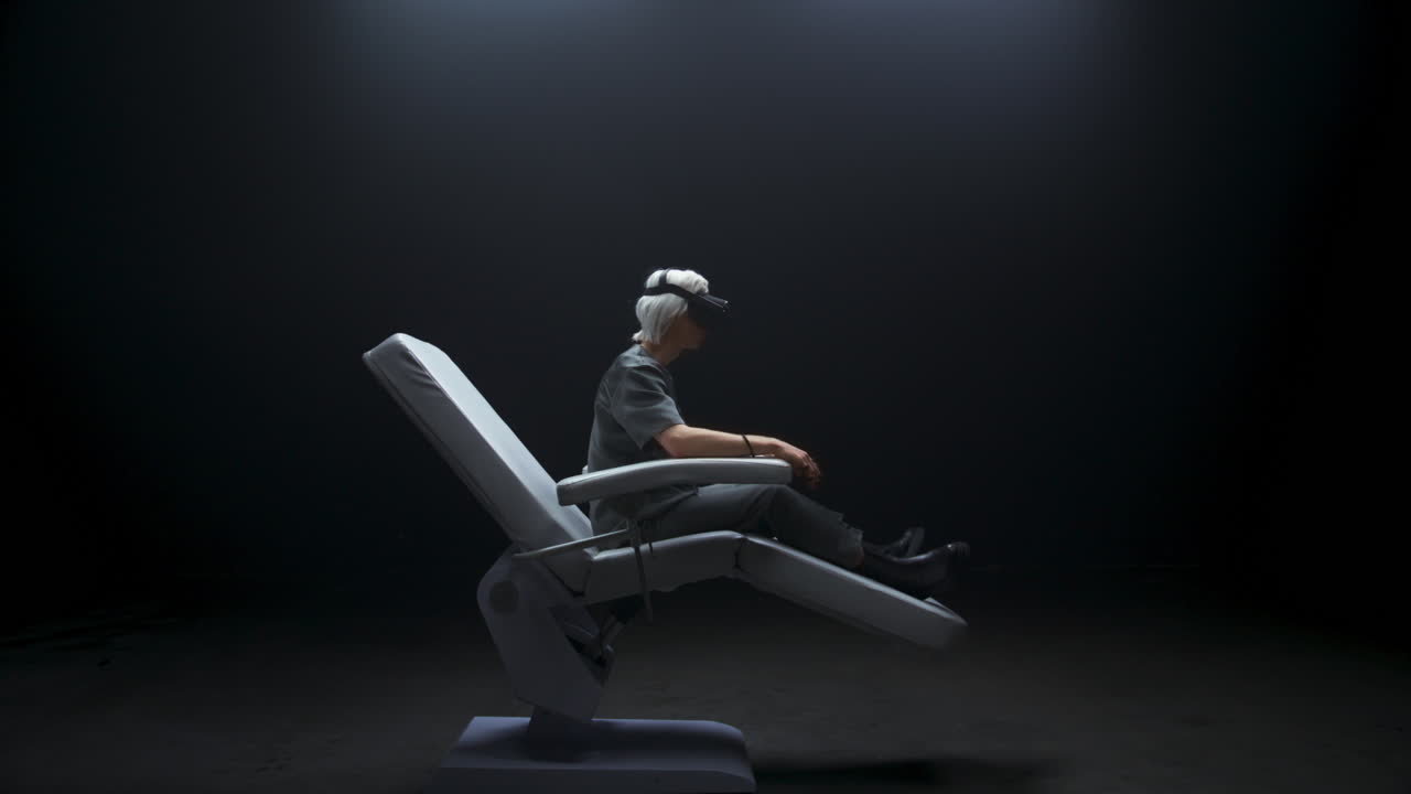 Thoughtful VR technologies user sitting exploring metaverse. Gamer playing
