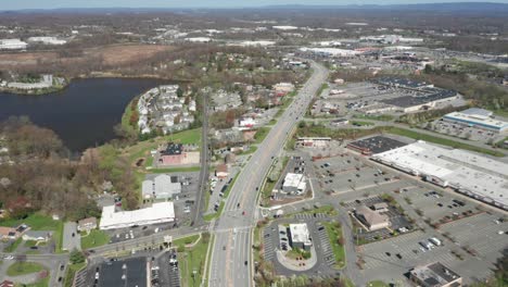 4K-Aerial-Drone-footage-of-industrial-shopping-centers-and-strip-malls-in-Middletown-New-York-and-traffics-can-be-seen-with-mountains-in-the-background