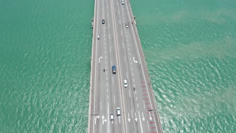 Aerial-view-of-Penang-Bridge-Malaysia-with-traffic-lanes-in-both-directions,-drone-bird's-eye-view-orbit-shot