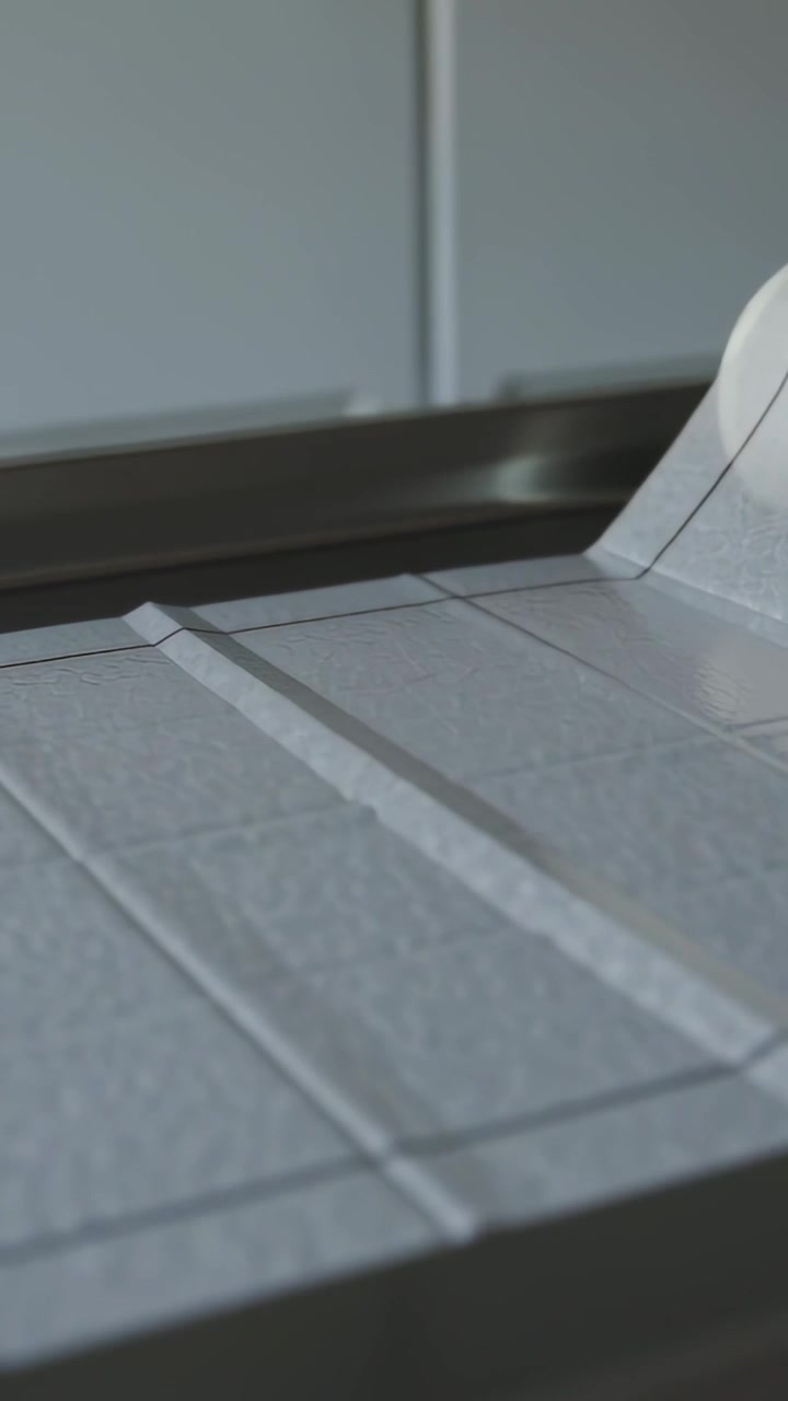 Vertical video: Peeling contact roll showing grid lines on kitchen worktop, exposing core to align