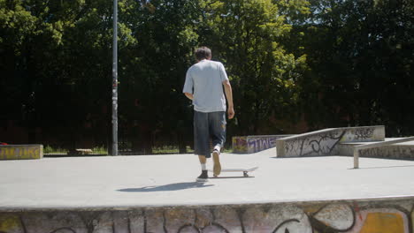 caucasian boy doing a trick in skatepark.