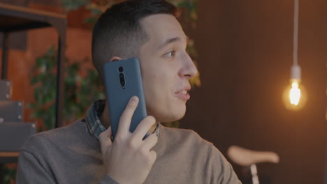 man talking on phone in office setting