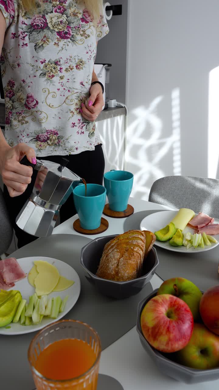 Bright morning breakfast setup with coffee, juice, fruit, bread, ham, cheese, and avocado on a stylish table. Cozy scene with sunlight ideal for food, lifestyle, or wellness content