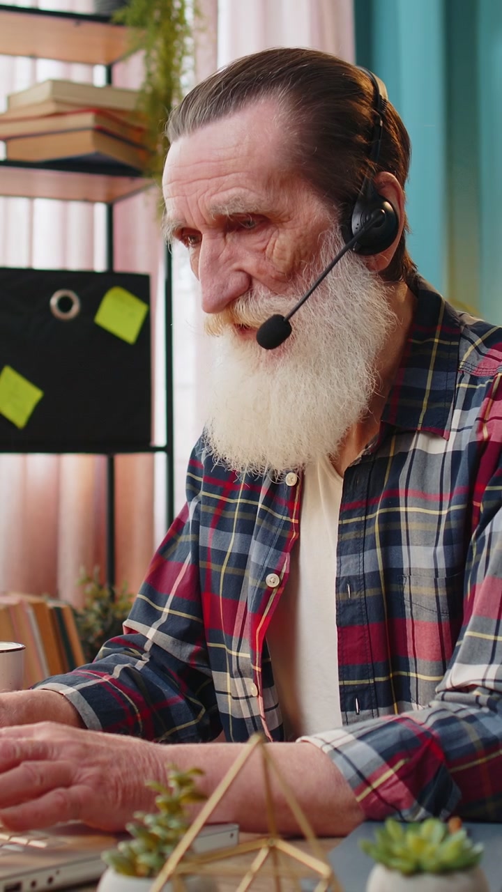 Ældre forretningsmand med headset, freelancer, callcenter- eller supportmedarbejder ved hjælpelinje