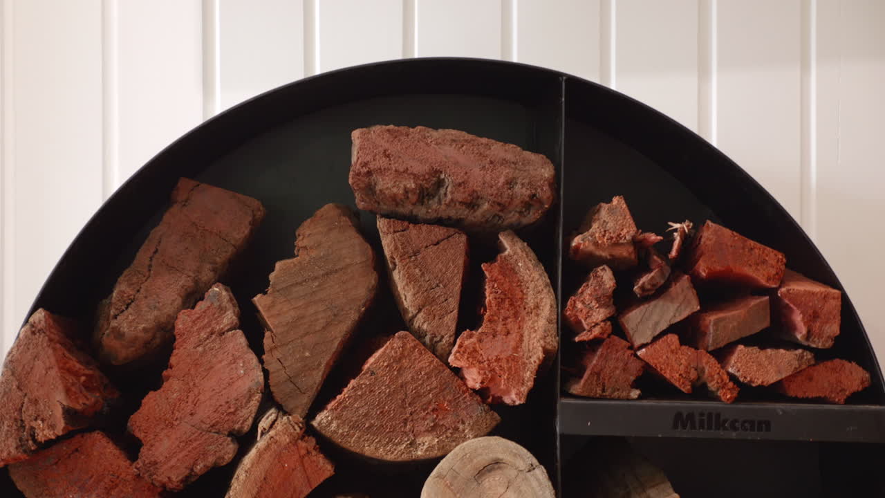 Neatly stacked firewood in circular round drum, TILT DOWN