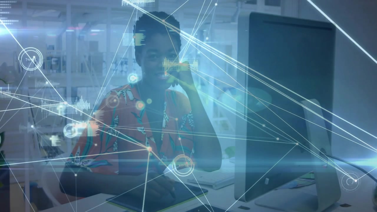 Woman taking call, drawing on tablet while network overlay connecting tablet to monitor for design