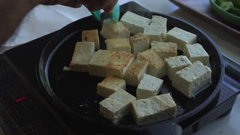 cooking tofu in a pan