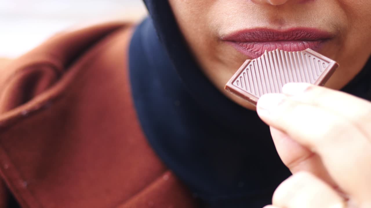 Woman eating chocolate