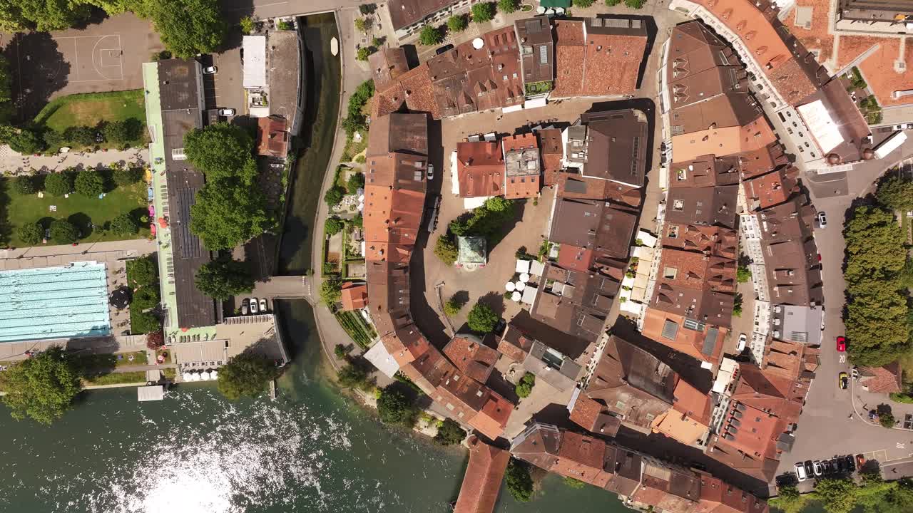 Top-down drone view of Olten – a charming historic town with traditional buildings clustered near the reflective river, capturing the peaceful character and layout of this Swiss destination