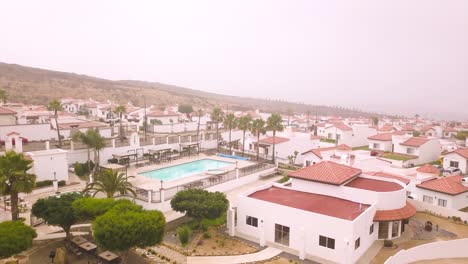 View-from-a-drone-ascending-over-rosarito-condominiums-in-Baja-California,-Mexico