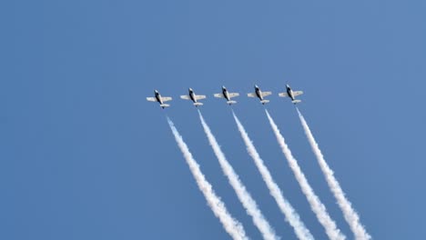 four military jet planes performing formation flight