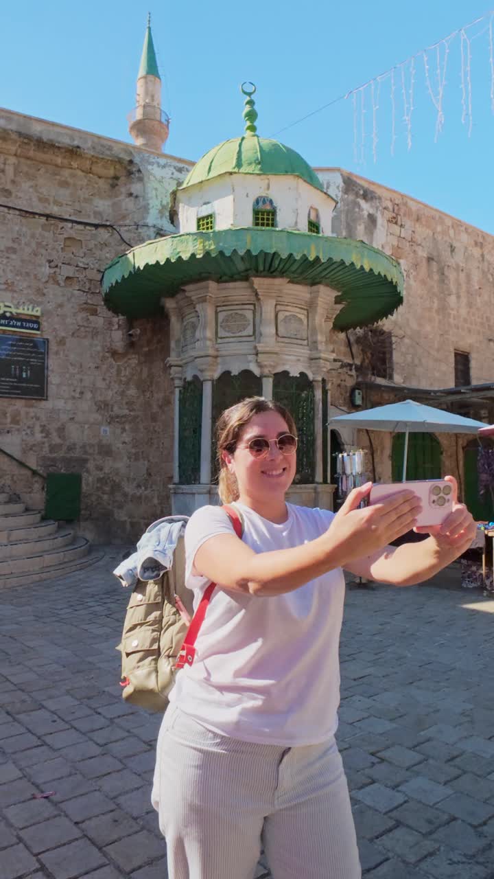 Cheerful woman taking selfie photo during summer vacation trip in Israel