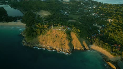 4K-Cinematic-nature-aerial-footage-of-a-drone-flying-over-the-beautiful-beaches-of-Promthep-Cape-in-Phuket,-Thailand-during-sunset