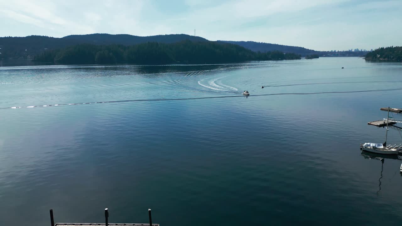 a scenic shot of speedboat under a clear sky coming to dock on private piers in North Vancouver