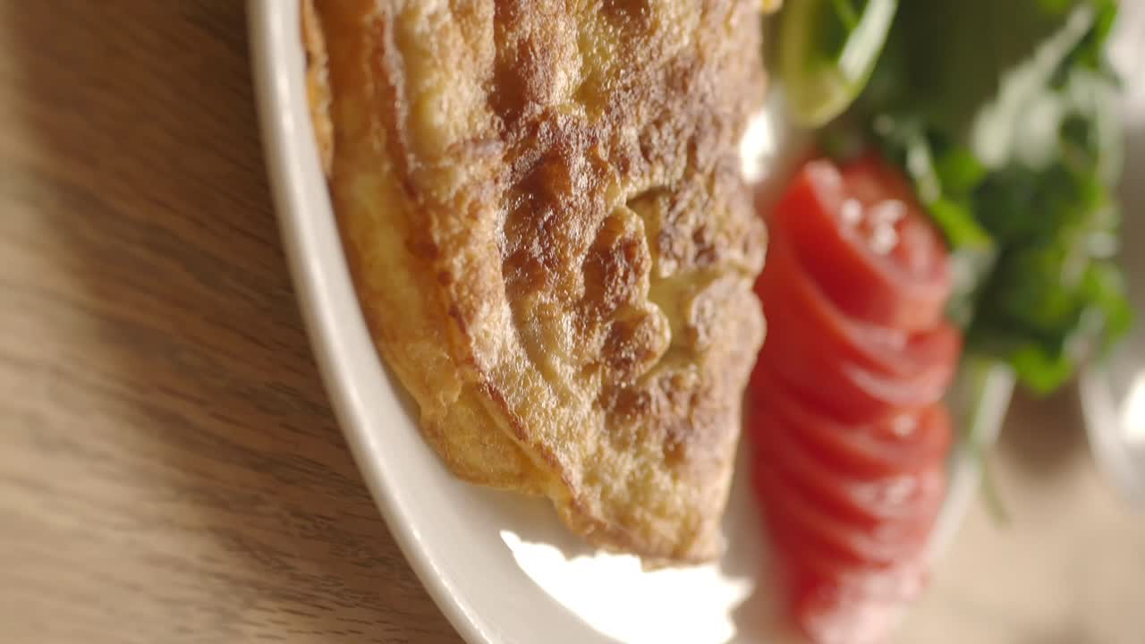 Close-up of a delicious omelet with a side salad