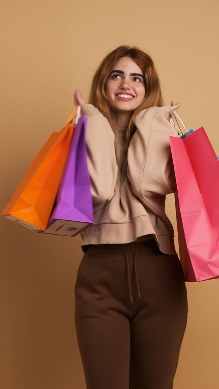 Young woman dancing happily facing the camera. Vertical Footage