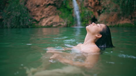 tranquil girl enjoying aqua activity emerald green water closeup. portrait woman