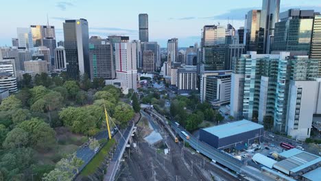 aerial shot of train coming out of tunnel leading into brisbane city central station