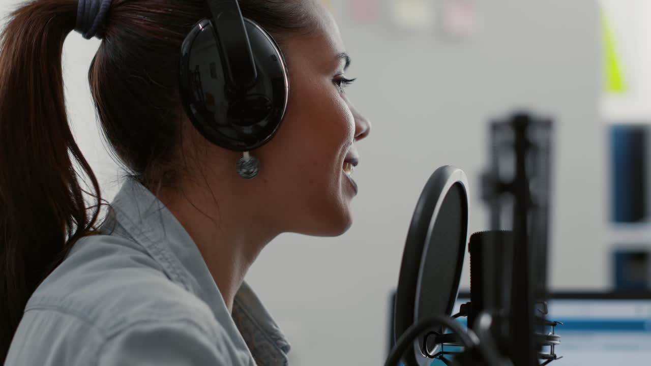 Attractive talk show host broadcasting while talking to audience in home studio